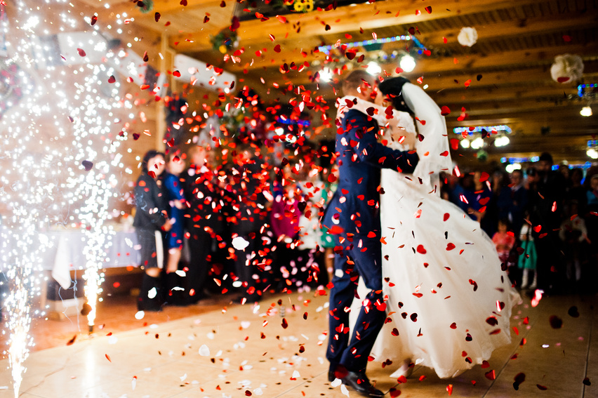 First wedding dance with fireworks and confetti, blured focus